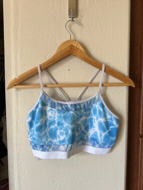 Victoria’s Secret sports bra featuring a blue and white water-inspired print wit